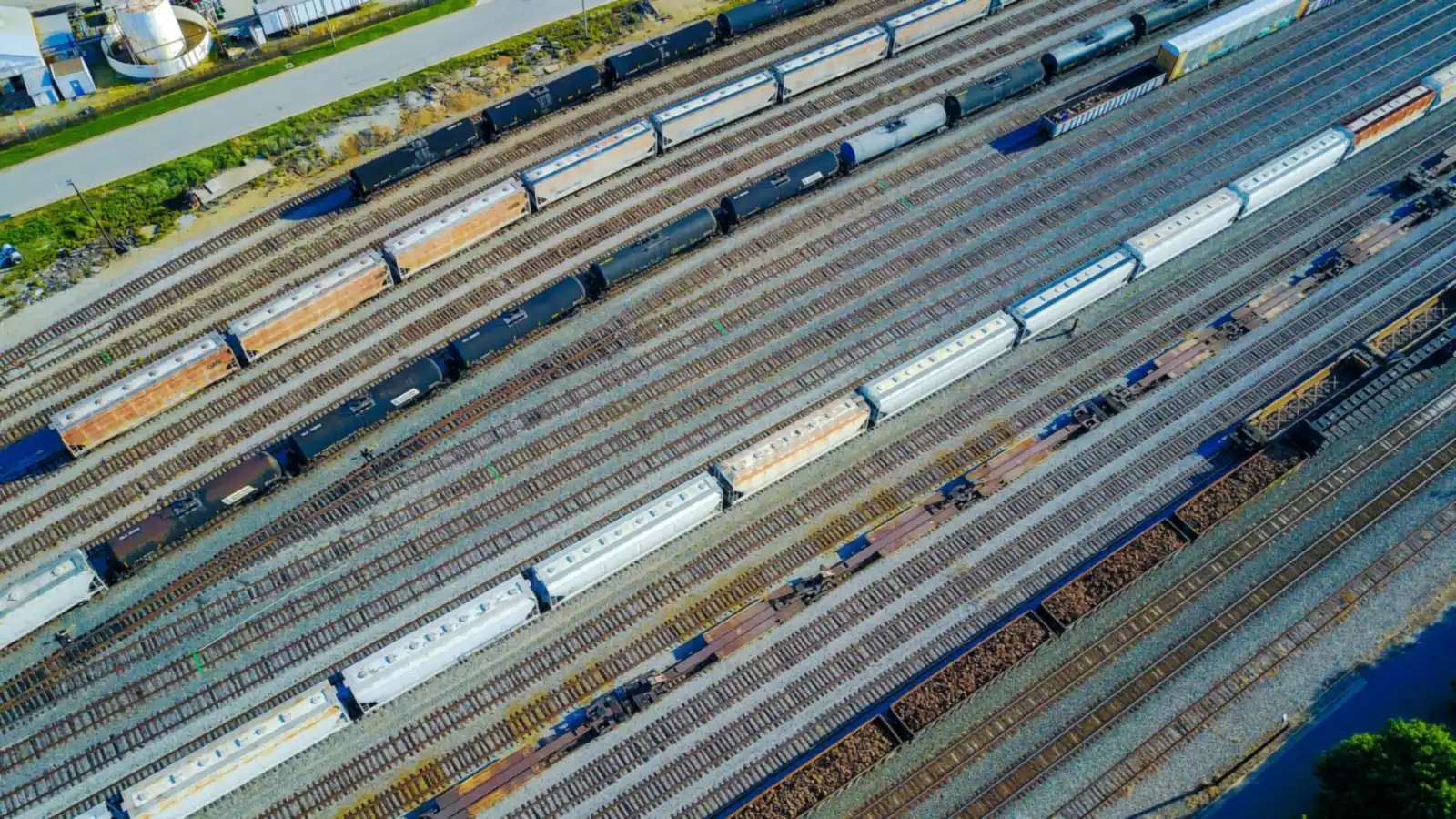 Aerial view of a rail yard with parallel tracks and freight cars.
